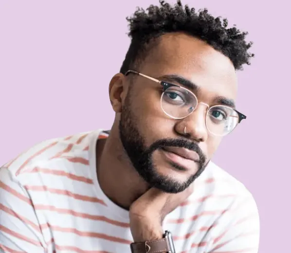 Man wearing glasses and striped shirt smiling